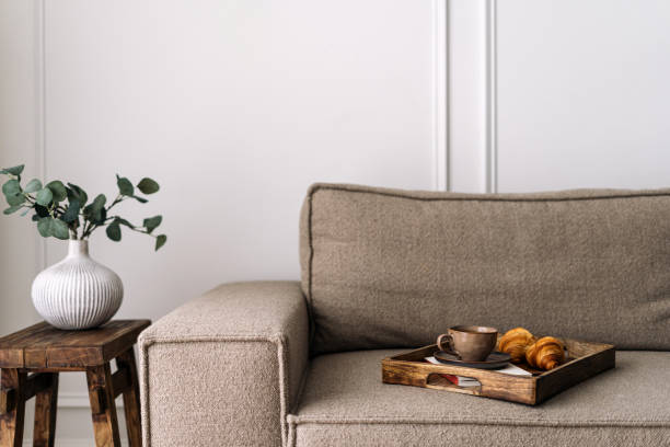 istock Comfort couch with breakfast tray close to side table with home decor 2169849773