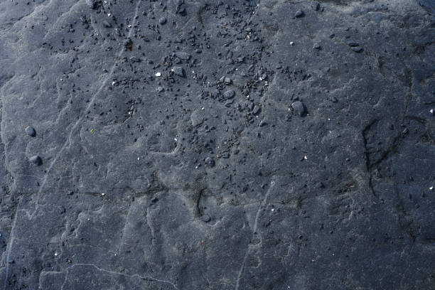 Dark rough natural rock background, directly above