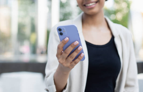 istock Young woman using smart phone in a city. Focus on smartphone 2169851159