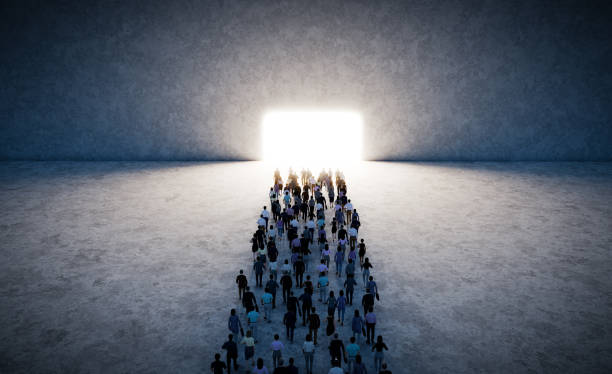 istock Crowd of people walking towards bright light gate in large space 2169852076