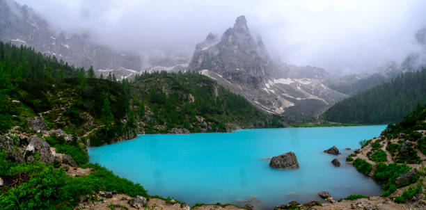 Lago di Sorapis (Lake Sorapis) in the Dolomites during an overcast springtime day with a strong turquoise color coming from dust from the glacier.
