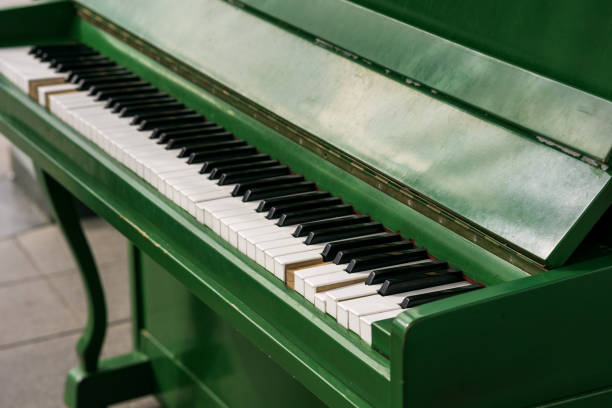 green street broken piano top view. an old piano for the street