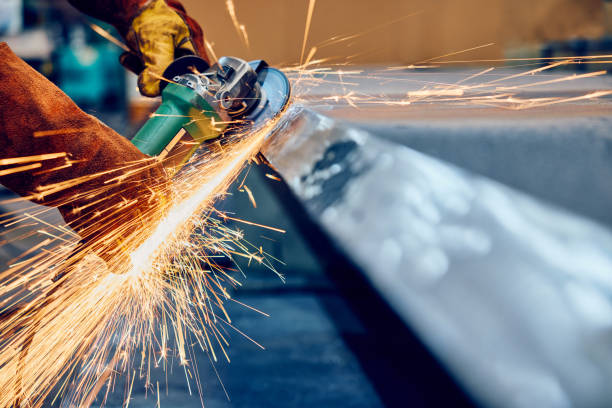 istock Industrial worker grinding metal with flying sparks 2169854789