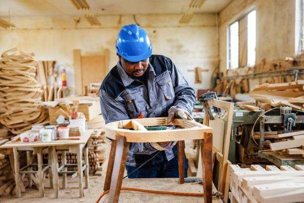 istock African American carpenter makes chair 2169856173