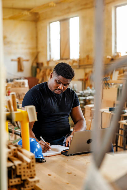 istock Small business owner makes plans for his workshop 2169856281