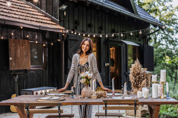 istock Enchanting Outdoor Dinner Setup by Smiling Hostess 2169858788