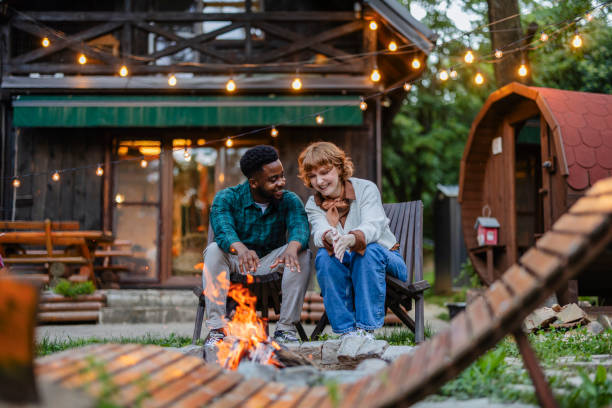 Cozy Campfire Chat: Couple Enjoying an Evening by the Fire