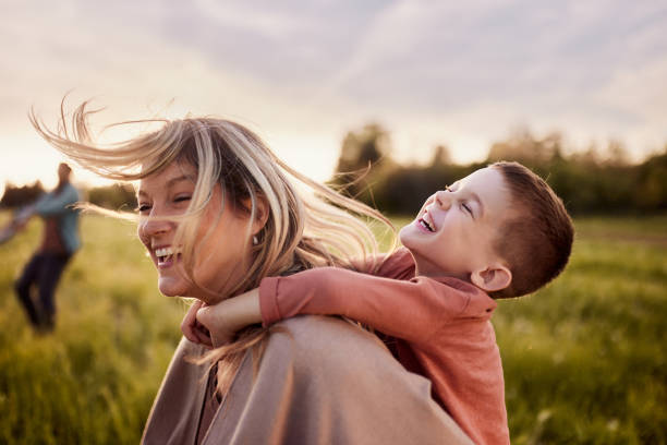istock Cheerful mother having fun with her son in nature. 2169863684