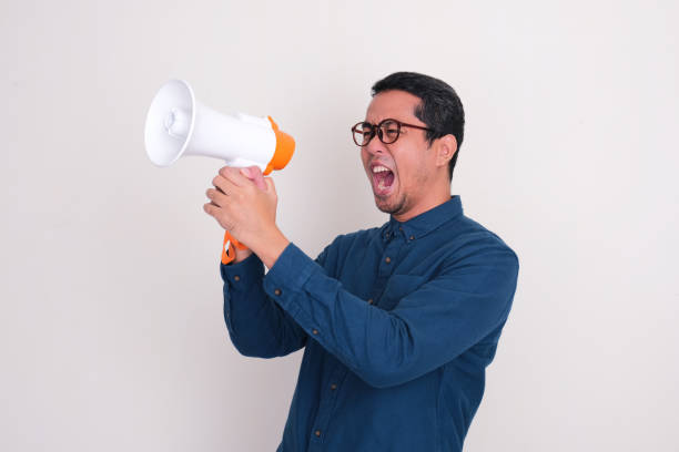 istock A man screaming loudly through megaphone 2169864630