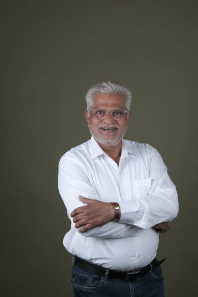 istock Confident Mature Man Smiling Against Off-White Background - Portrait 2169864728