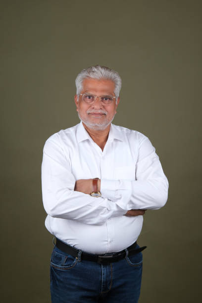 istock Confident Mature Man Smiling Against Off-White Background - Portrait 2169864794