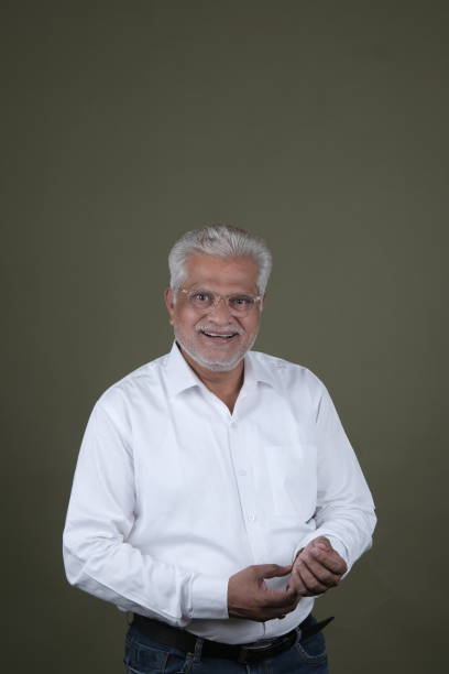 istock Confident Mature Man Smiling Against Off-White Background - Portrait 2169864795