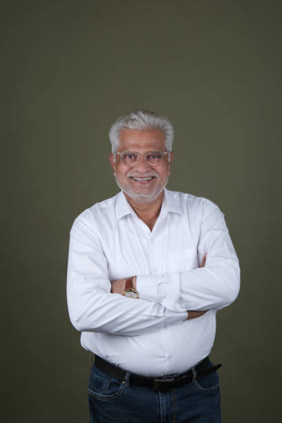 Confident Mature Man Smiling Against Off-White Background - Portrait