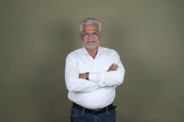 istock Confident Mature Man Smiling Against Off-White Background - Portrait 2169864861
