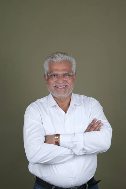 istock Confident Mature Man Smiling Against Off-White Background - Portrait 2169864862