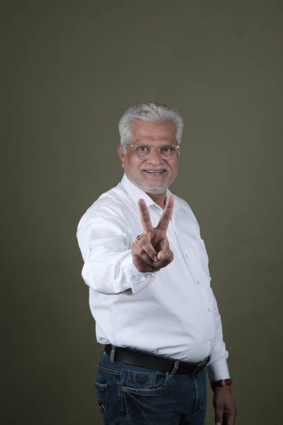istock Confident Mature Man Smiling Against Off-White Background - Portrait 2169864900