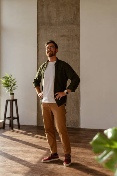 istock Smiling interior designer in eyeglasses looking away in apartment 2169864918