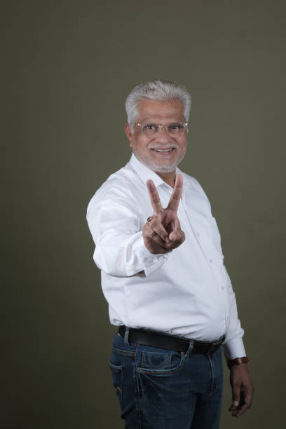 istock Confident Mature Man Smiling Against Off-White Background - Portrait 2169864953