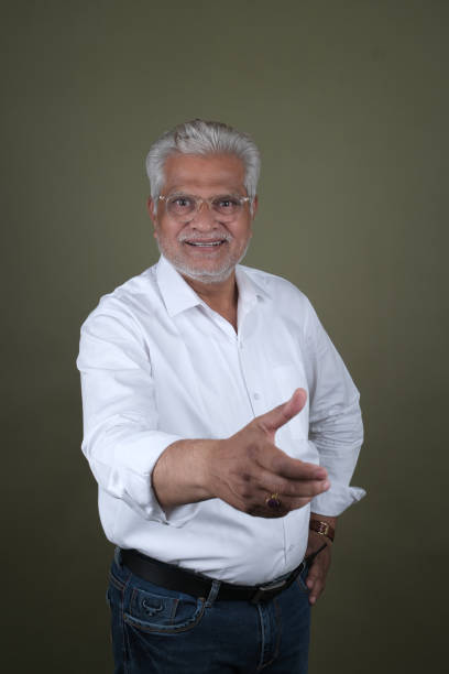 istock Confident Mature Man Smiling Against Off-White Background - Portrait 2169865118
