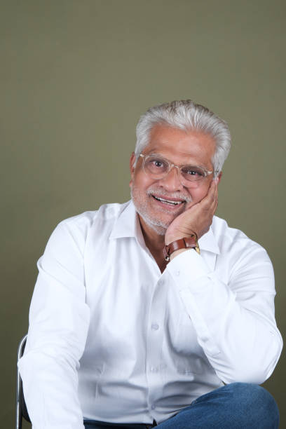 istock Confident Mature Man Smiling Against Off-White Background - Portrait 2169865125