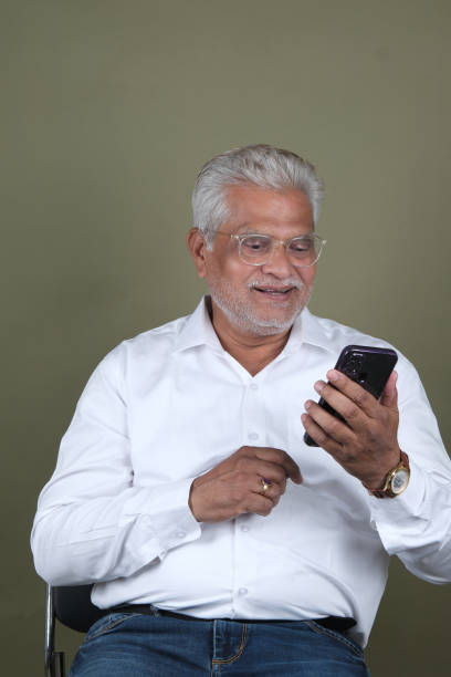 istock Confident Mature Man Smiling Against Off-White Background - Portrait 2169865165