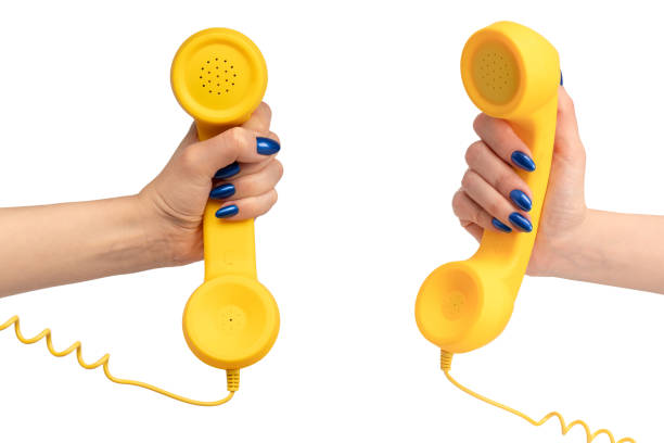 istock Yellow handset in woman hand isolated on white. Copy space. 2169865282