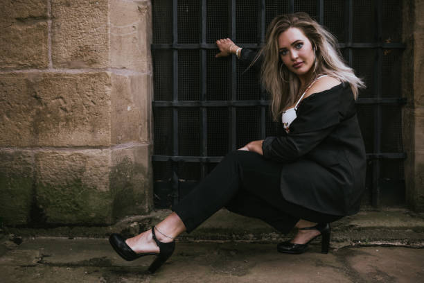 istock woman in black is posing for a photo 2169865477