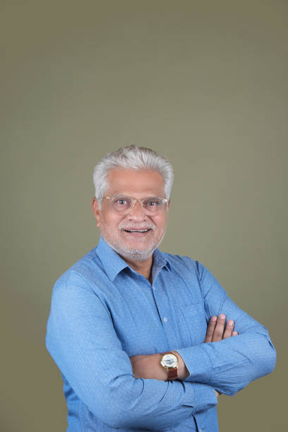 istock Confident Mature Man Smiling Against Off-White Background - Portrait 2169865683