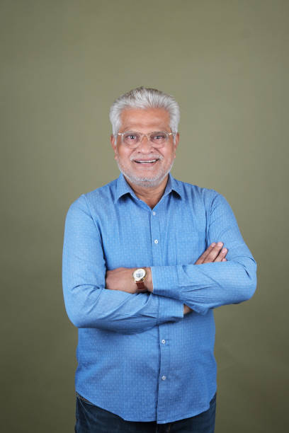 istock Confident Mature Man Smiling Against Off-White Background - Portrait 2169865726