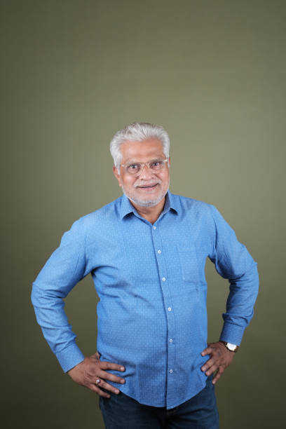 istock Confident Mature Man Smiling Against Off-White Background - Portrait 2169865759