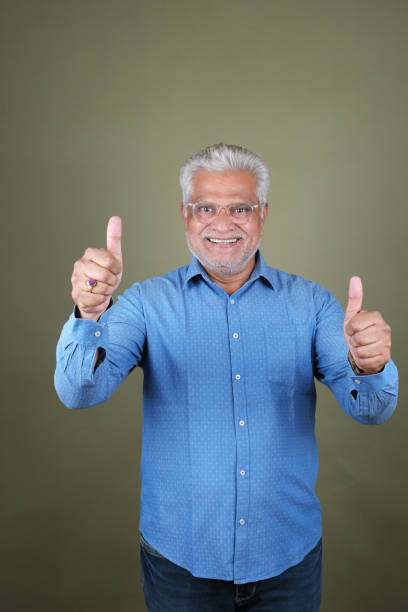 istock Confident Mature Man Smiling Against Off-White Background - Portrait 2169865798