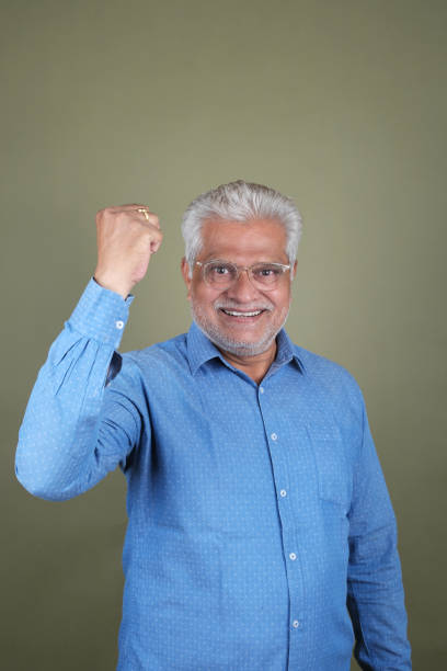 istock Confident Mature Man Smiling Against Off-White Background - Portrait 2169865865
