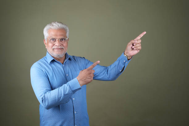 Confident Mature Man Smiling Against Off-White Background - Portrait