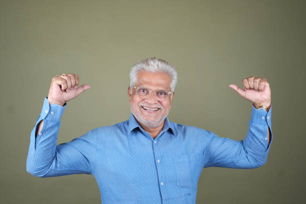 istock Confident Mature Man Smiling Against Off-White Background - Portrait 2169865924