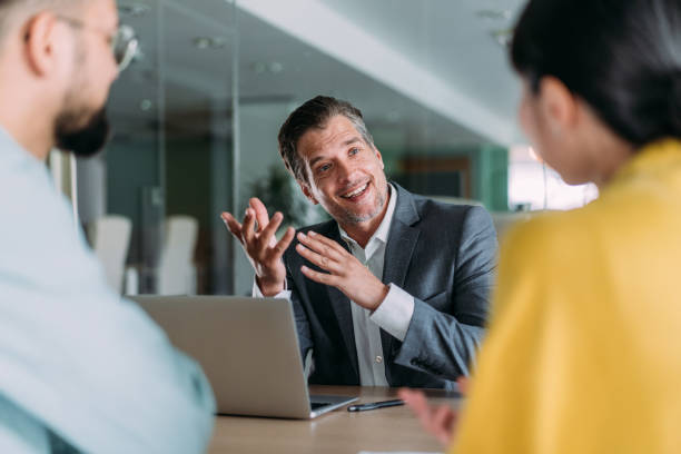 istock Group of business persons talking in the office. 2169865931