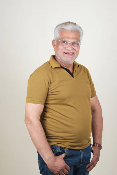 istock Confident Mature Man Smiling Against Off-White Background - Portrait 2169866726