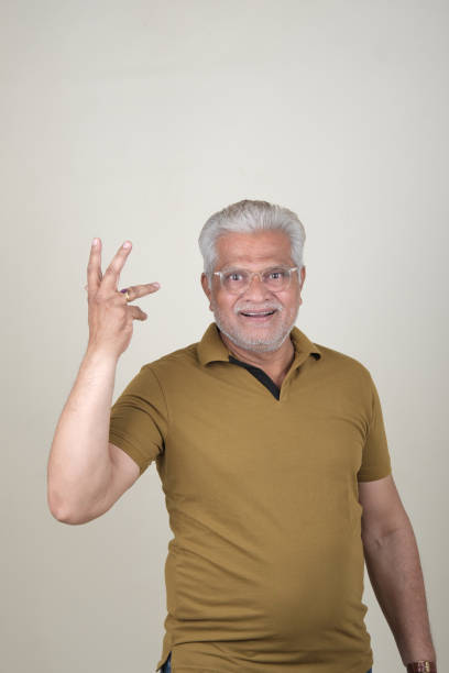 istock Confident Mature Man Smiling Against Off-White Background - Portrait 2169866769