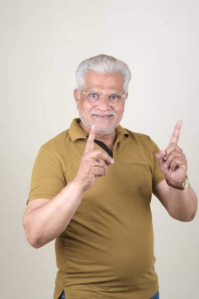 istock Confident Mature Man Smiling Against Off-White Background - Portrait 2169866796