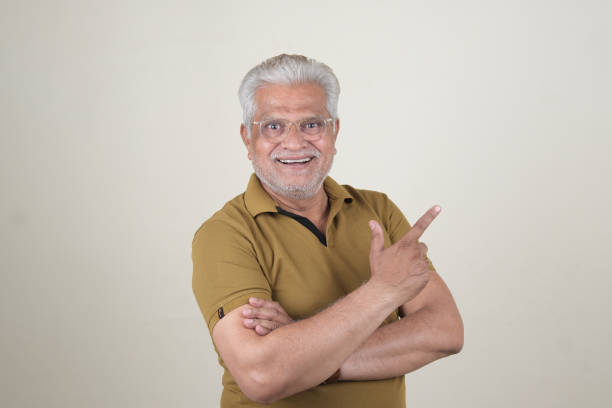 istock Confident Mature Man Smiling Against Off-White Background - Portrait 2169866827