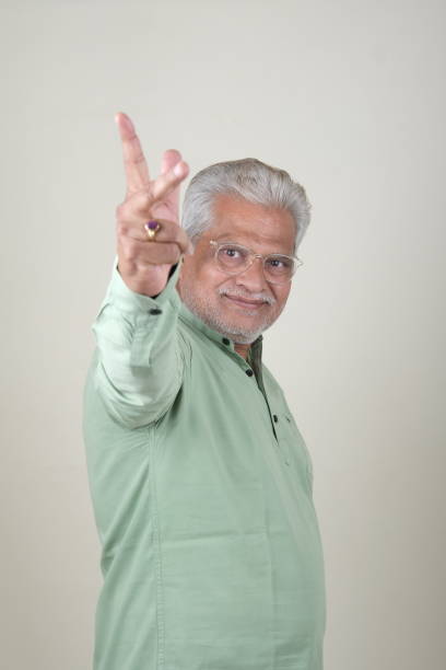 istock Confident Mature Man Smiling Against Off-White Background - Portrait 2169866887