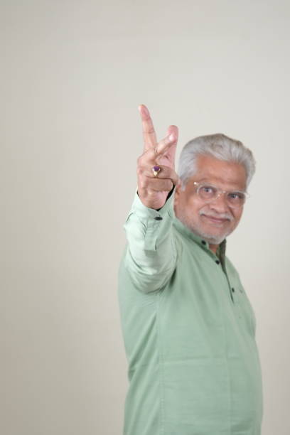 istock Confident Mature Man Smiling Against Off-White Background - Portrait 2169866911