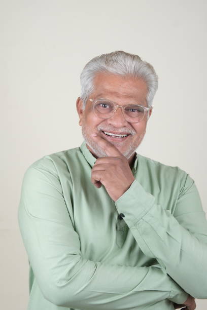 istock Confident Mature Man Smiling Against Off-White Background - Portrait 2169866939