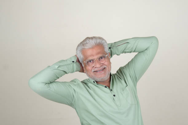 A close-up portrait of a mature man with a warm, genuine smile against an off-white background. The image captures a sense of confidence, experience, and positivity, making it ideal for use in professional, lifestyle, or wellness-related content. The neutral background allows for versatile application in various designs and marketing materials.