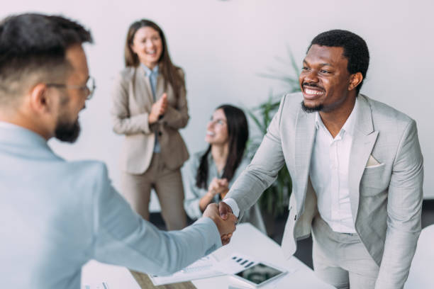 istock Businesspeople shaking hands across the table. 2169867071