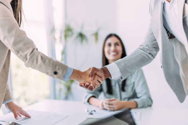 istock Businesspeople shaking hands across the table. 2169867085