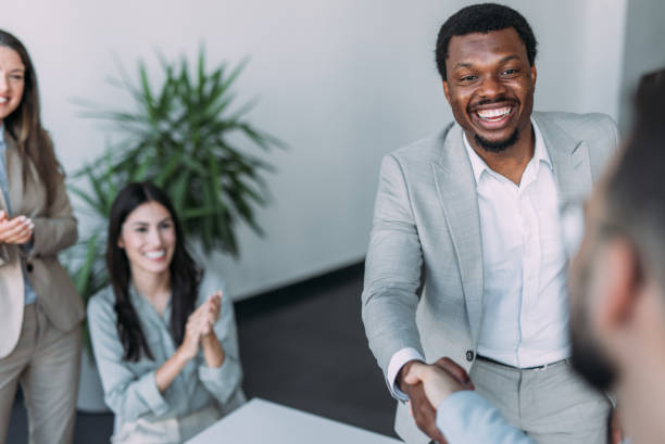 istock Businesspeople shaking hands across the table. 2169867089