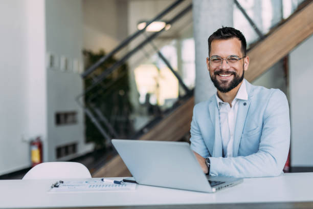 istock Successful businessman in modern office working on laptop. 2169867129