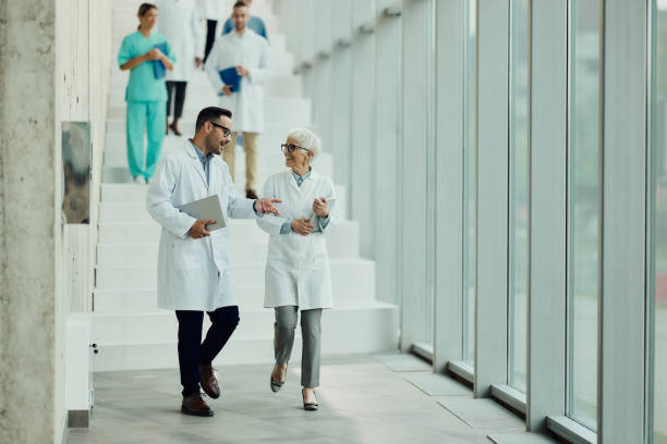 istock Happy doctors talking while walking through hallway of a hospital. 2169868809