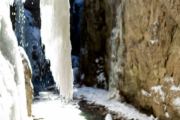 Snow, ice and spray of cold water in/near a stream of water (or a small waterfall) in Jotunheimen National Park, Norway, in early winter (October). The image was captured with a full frame DSLR camera and a sharp lens at low ISO. The photograph is part of a series of images of Jotunheimen National Park at various seasons.