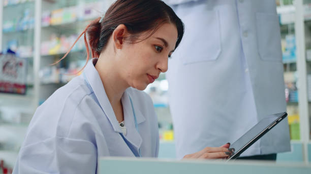 istock Young female pharmacist checking inventory in medical store. 2169869507